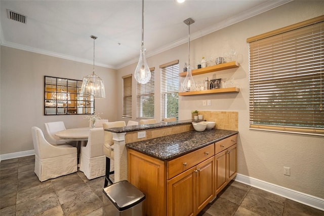 kitchen featuring kitchen peninsula, dark stone countertops, pendant lighting, and ornamental molding