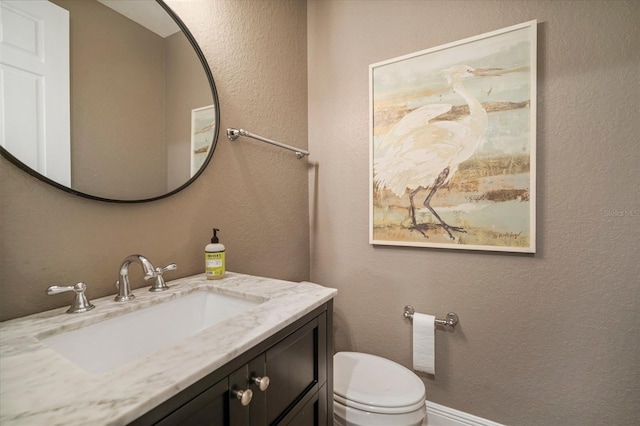 bathroom featuring toilet and vanity