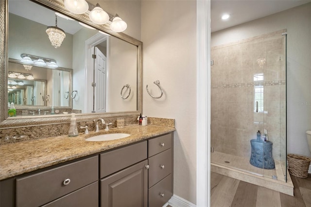 bathroom featuring vanity, tiled shower, and hardwood / wood-style floors