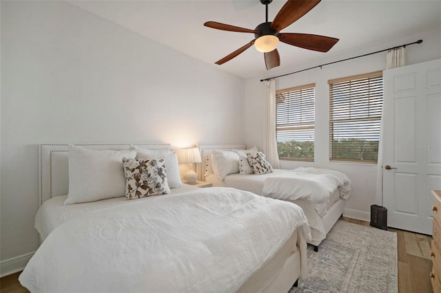 bedroom with ceiling fan and light hardwood / wood-style floors