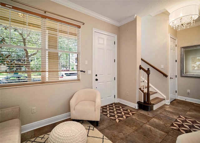 entrance foyer featuring an inviting chandelier and crown molding