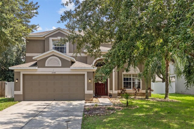 view of front of home featuring a garage and a front yard