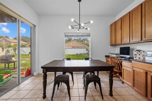 tiled dining space featuring a chandelier