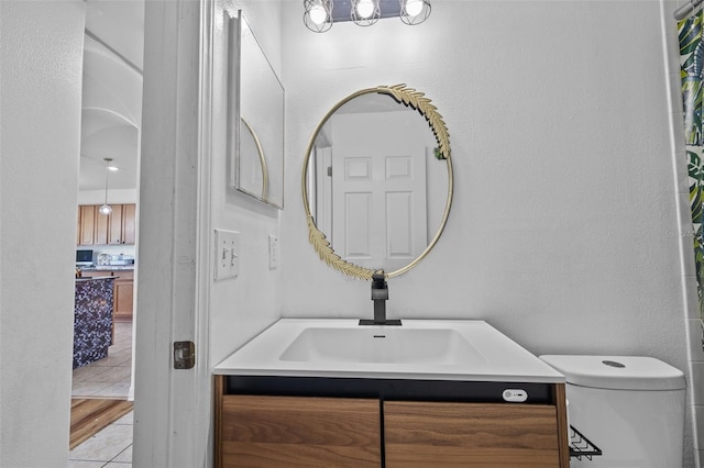 bathroom featuring vanity, tile patterned flooring, and toilet