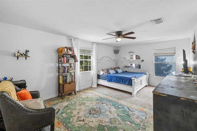 bedroom featuring light carpet and ceiling fan