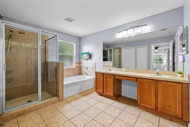 bathroom with independent shower and bath, tile patterned floors, and double sink vanity