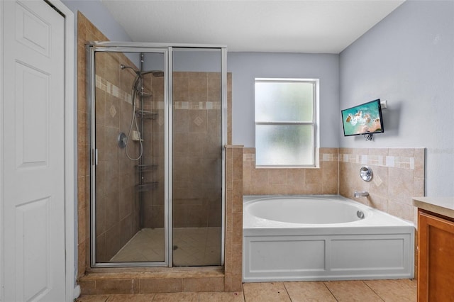 bathroom with vanity, tile patterned flooring, and separate shower and tub