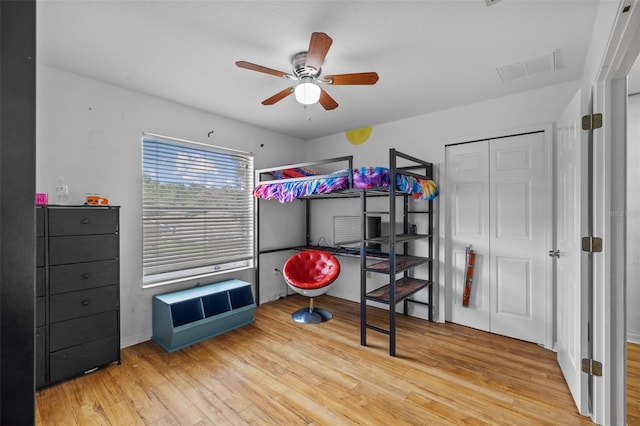 bedroom with ceiling fan and light hardwood / wood-style floors