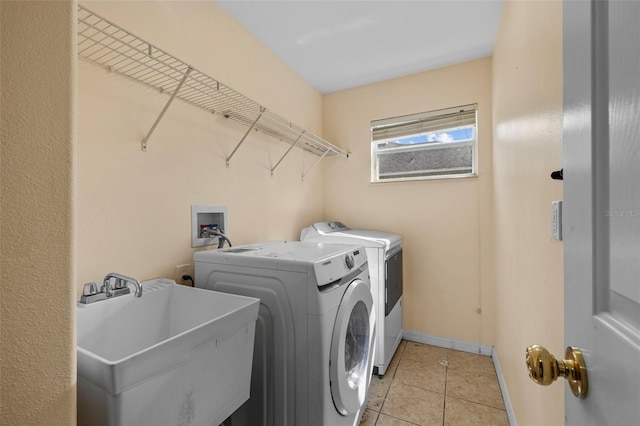 laundry room with sink, light tile patterned flooring, and washer and dryer