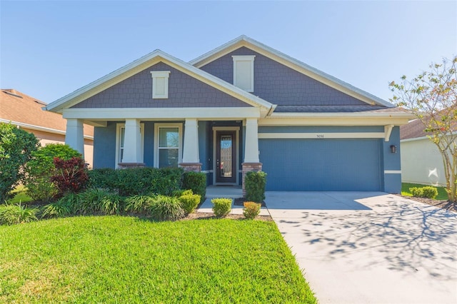 craftsman-style home featuring a garage and a front yard