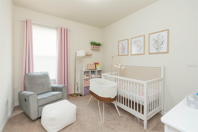 bedroom featuring light colored carpet, multiple windows, and a nursery area