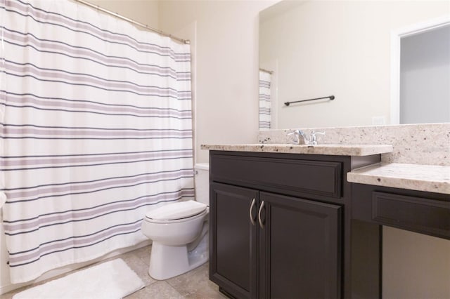 bathroom featuring tile patterned flooring, vanity, and toilet