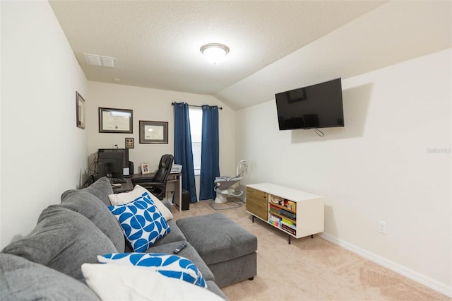 carpeted living room with lofted ceiling and a textured ceiling