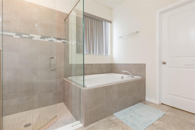 bathroom featuring tile patterned floors and separate shower and tub