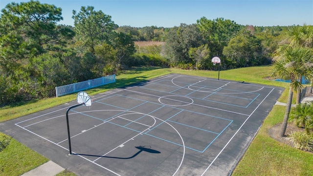 view of basketball court featuring a yard