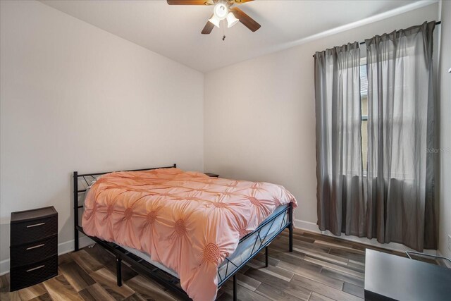 bedroom featuring ceiling fan and dark hardwood / wood-style floors