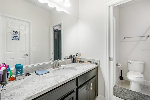 bathroom with vanity, toilet, and tile patterned floors