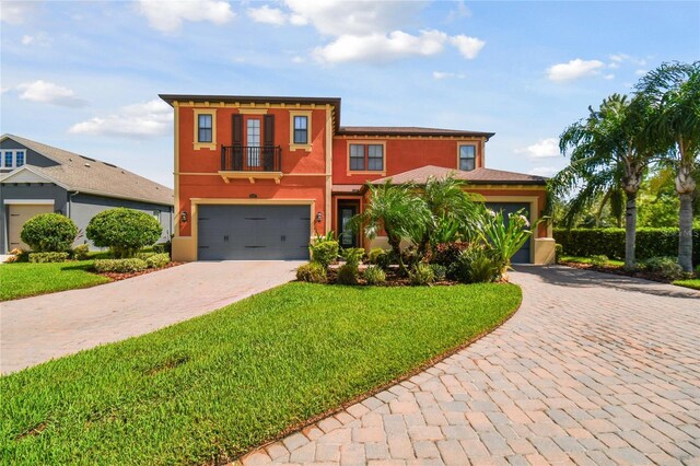 view of front of house with a front yard and a garage