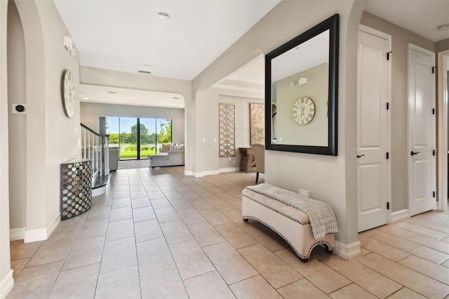 hall featuring light tile patterned flooring