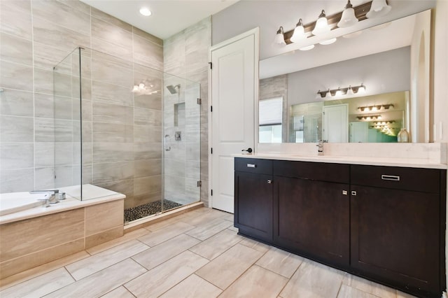 bathroom with tile patterned floors, vanity, and separate shower and tub