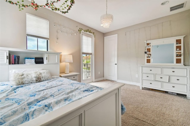 bedroom with a chandelier and light carpet