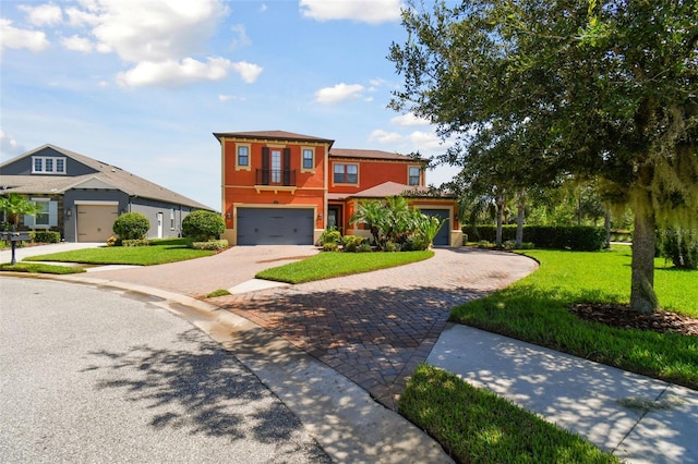 view of front of property featuring a front yard and a garage