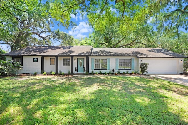 single story home with a garage and a front lawn