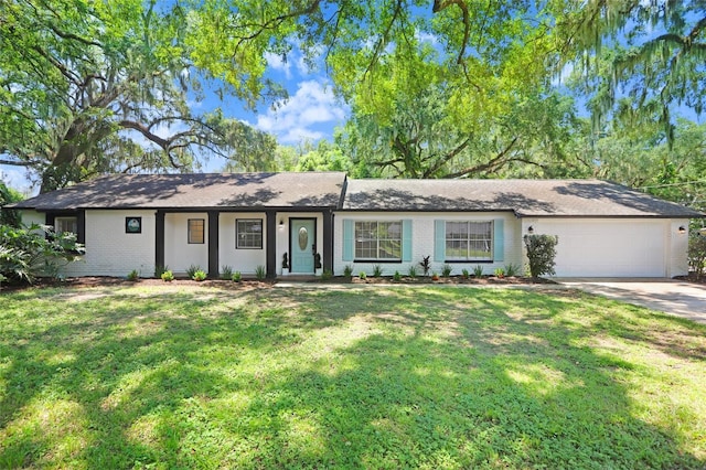 ranch-style home with a front yard, brick siding, driveway, and an attached garage