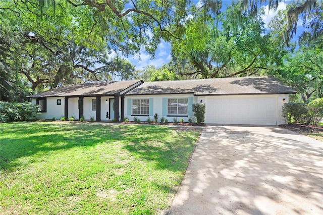 ranch-style home with a garage and a front lawn