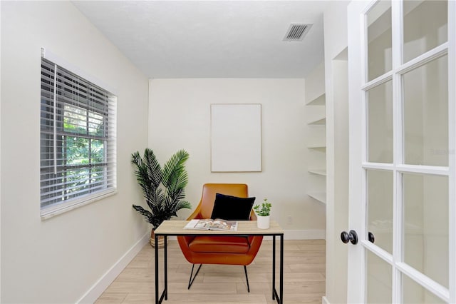 home office featuring light wood-type flooring and french doors