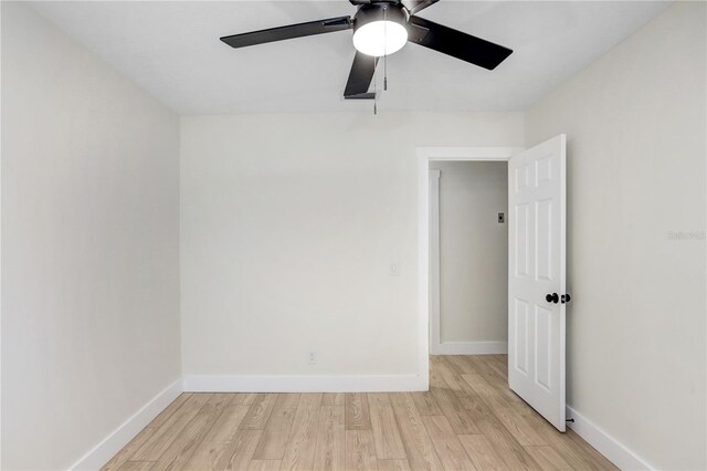 empty room with ceiling fan and light hardwood / wood-style flooring