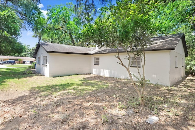 view of property exterior with concrete block siding