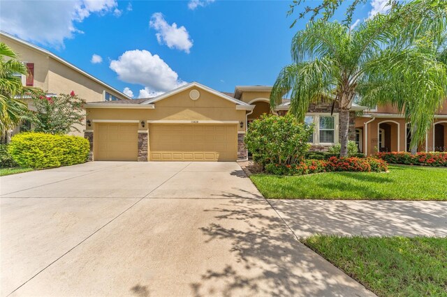 view of front of home with a front lawn and a garage