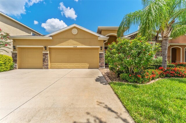 view of front of home featuring a front yard and a garage