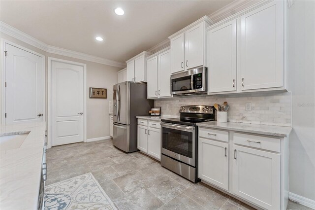 kitchen with light stone counters, decorative backsplash, stainless steel appliances, and white cabinetry