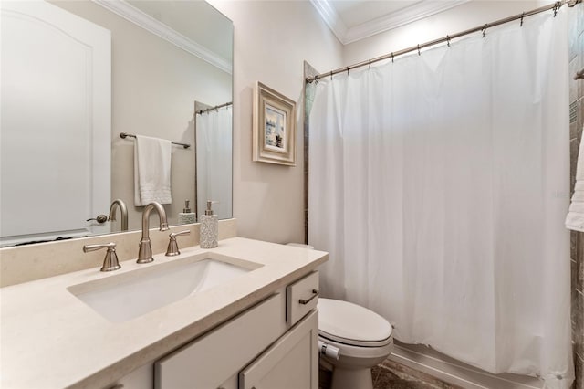 bathroom with crown molding, vanity, and toilet