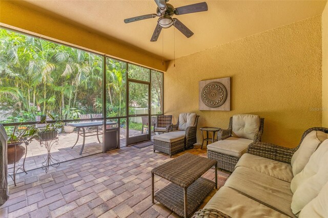 sunroom featuring ceiling fan