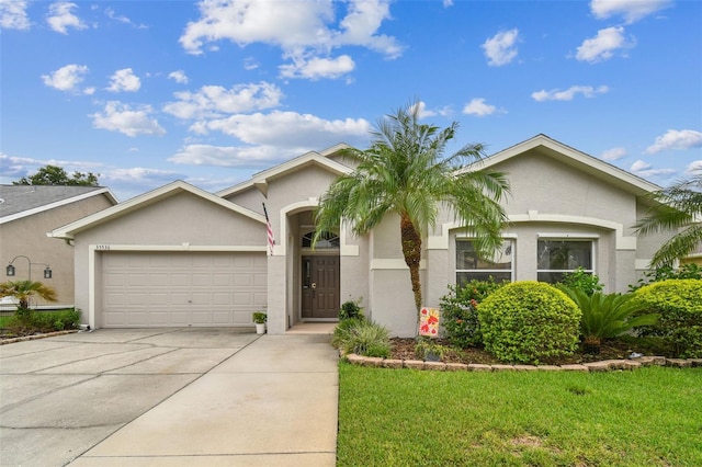 ranch-style house featuring a front lawn and a garage