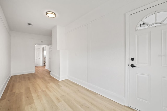 hall with light hardwood / wood-style floors