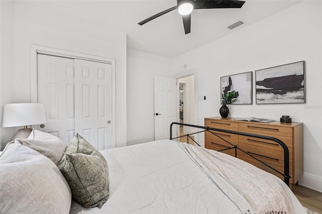 bedroom featuring ceiling fan, a closet, and wood-type flooring