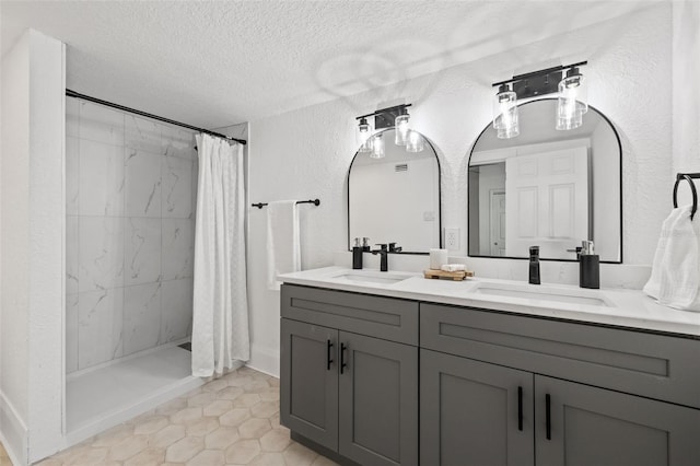 bathroom featuring tile patterned floors, a textured ceiling, double vanity, and a shower with curtain