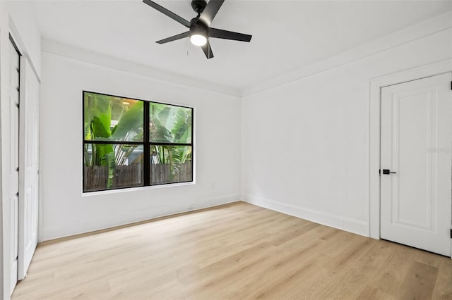 unfurnished bedroom featuring ceiling fan, crown molding, and light wood-type flooring