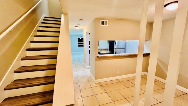 staircase with tile patterned floors