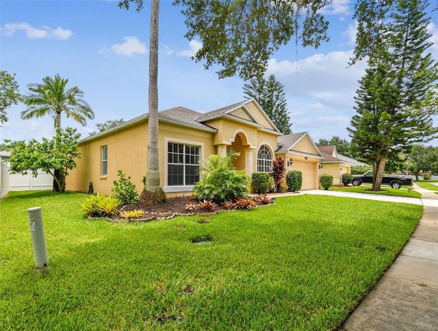 view of front of home with a front yard and a garage