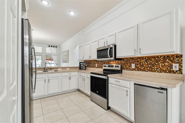 kitchen featuring tasteful backsplash, white cabinetry, and appliances with stainless steel finishes