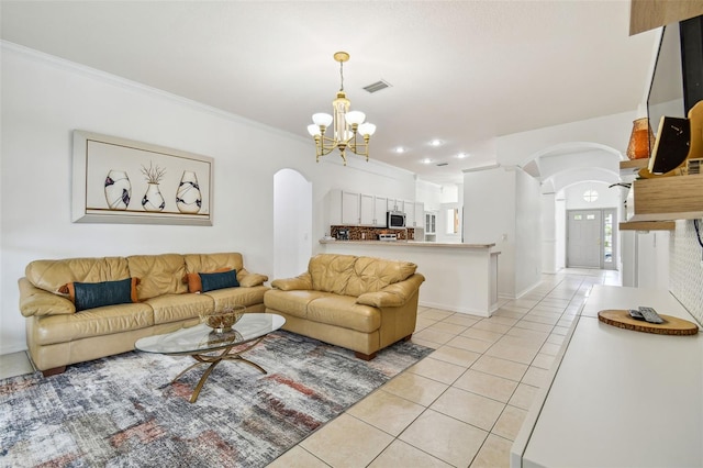 living room featuring light tile patterned floors, crown molding, and a notable chandelier