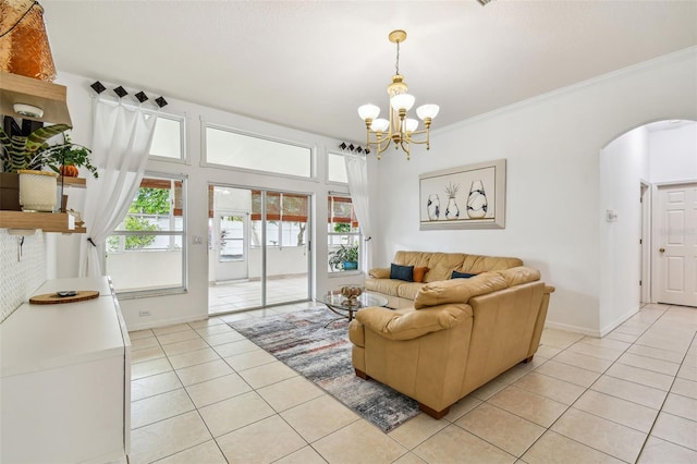 living room featuring crown molding, light tile patterned flooring, and a chandelier