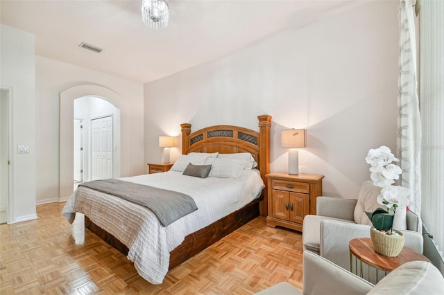 bedroom featuring light parquet floors and a closet