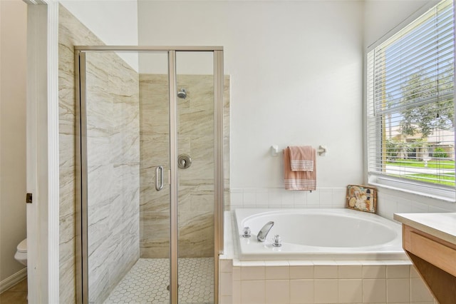 full bathroom featuring vanity, independent shower and bath, and toilet