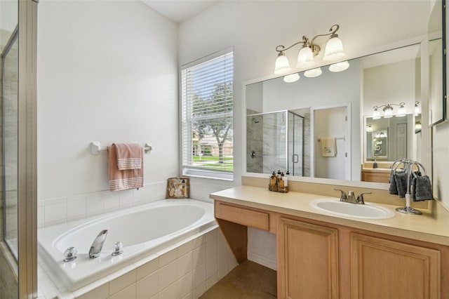 bathroom with tile patterned flooring, shower with separate bathtub, and vanity